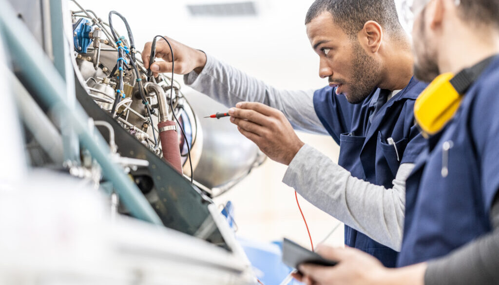 Two men working on aerospace equipment.