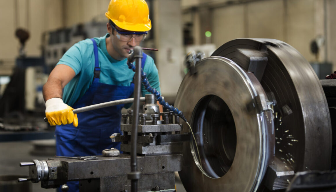 A man working at a machinery shop.